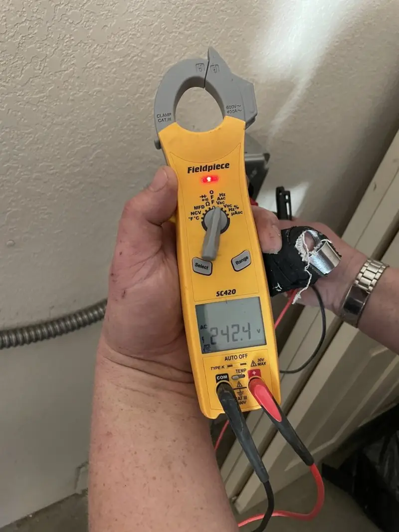 Voltage testing with clamp meter during Whole House Surge Protector in Ontario
